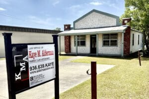 Jasper family law office of Kaye M. Alderman with the firm's roadside sign in front of the building.
